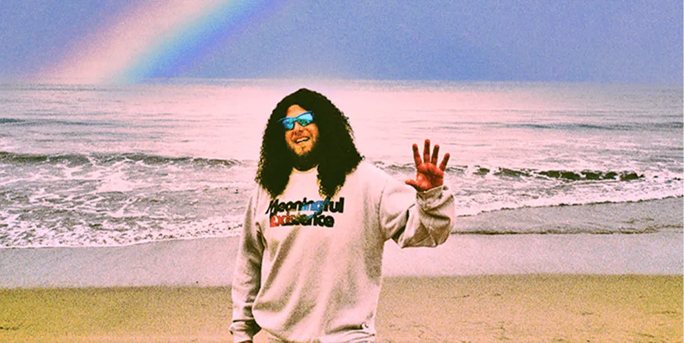 Person on beach waving at camera